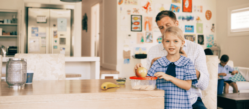 A father a daughter in the kitchen making lunch