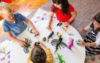 children playing in a group at a table
