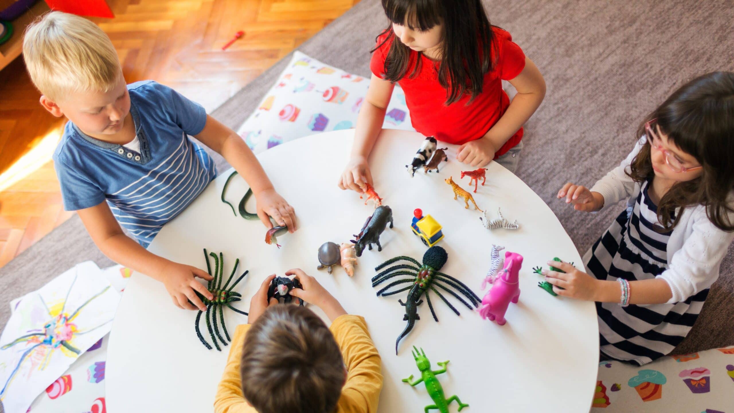 children playing in a group at a table